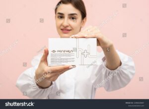 stock-photo-close-up-of-a-female-cosmetologist-s-hand-holding-a-white-brand-box-of-beauty-injections-with-2296420697